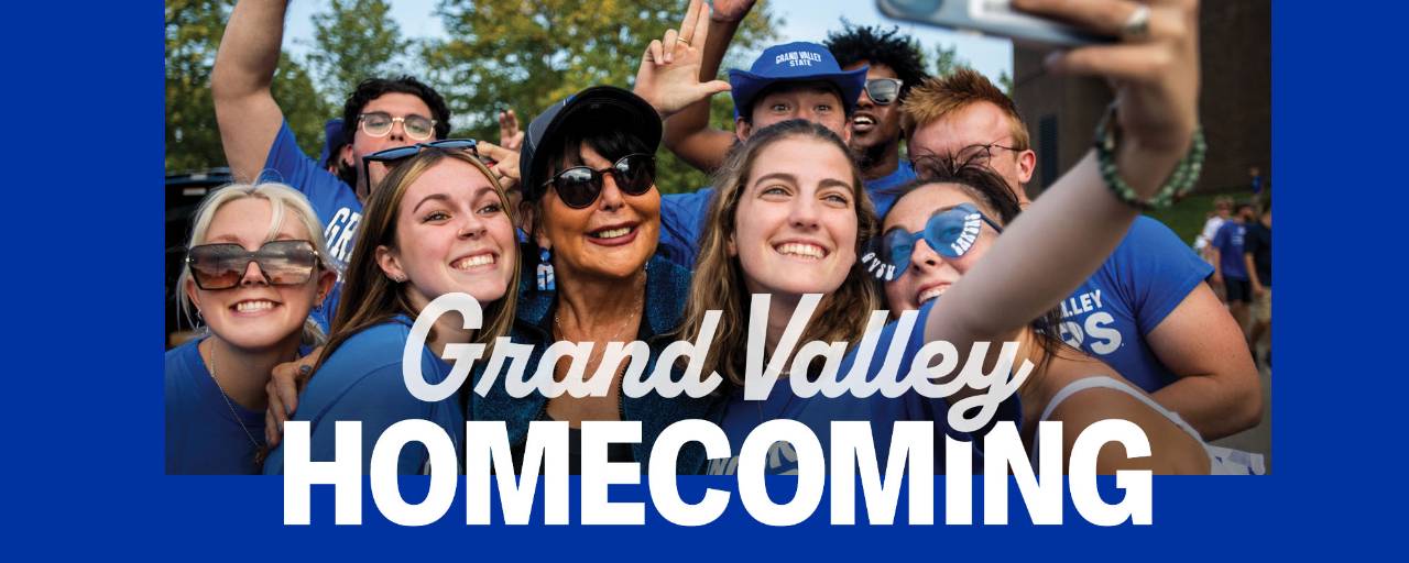 President Mantella smiles with students with text Grand Valley Homecoming